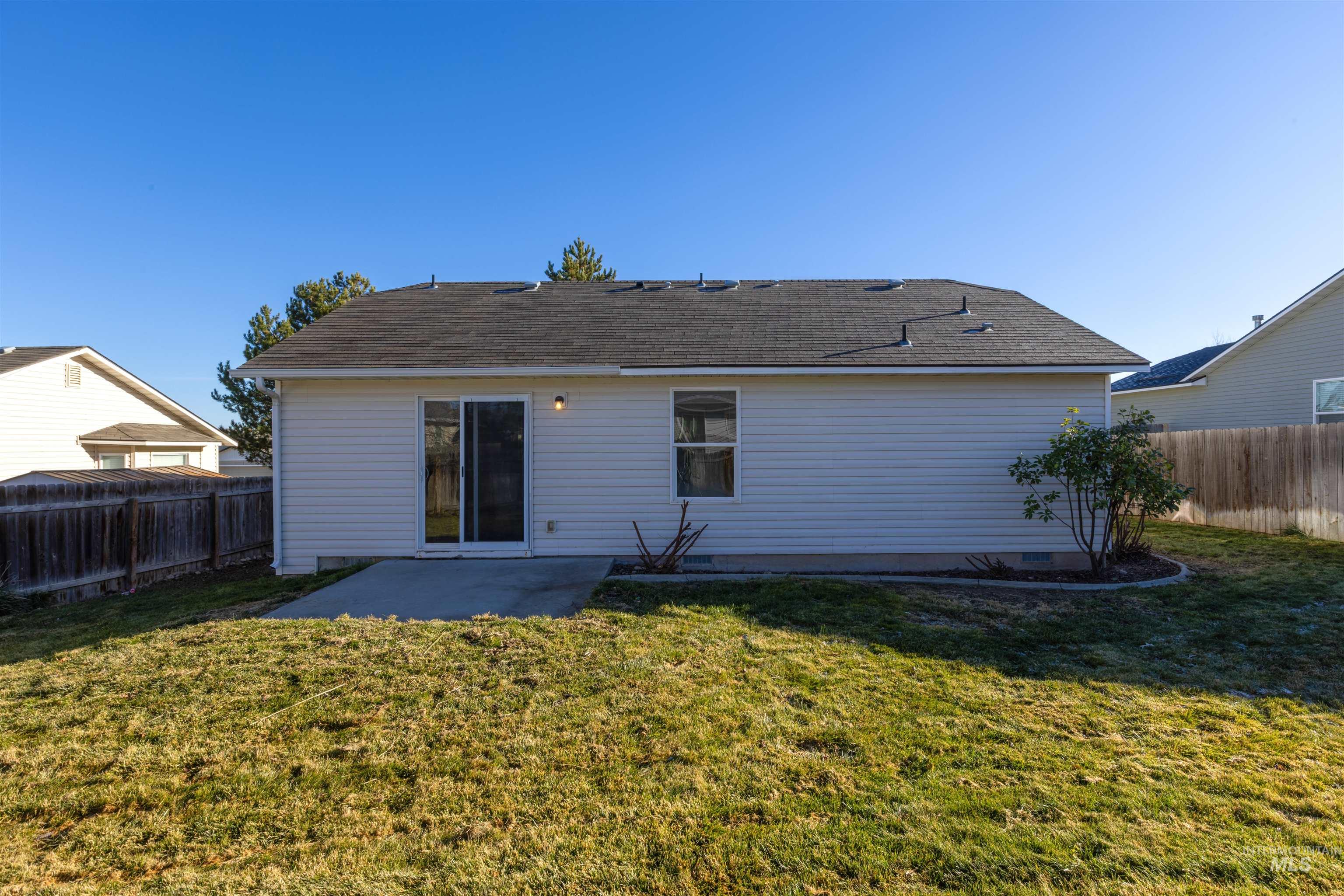 16535 Chino Avenue Caldwell, ID 83607 - Photo 25 of 26 Back of house with a patio area and a fenced backyard