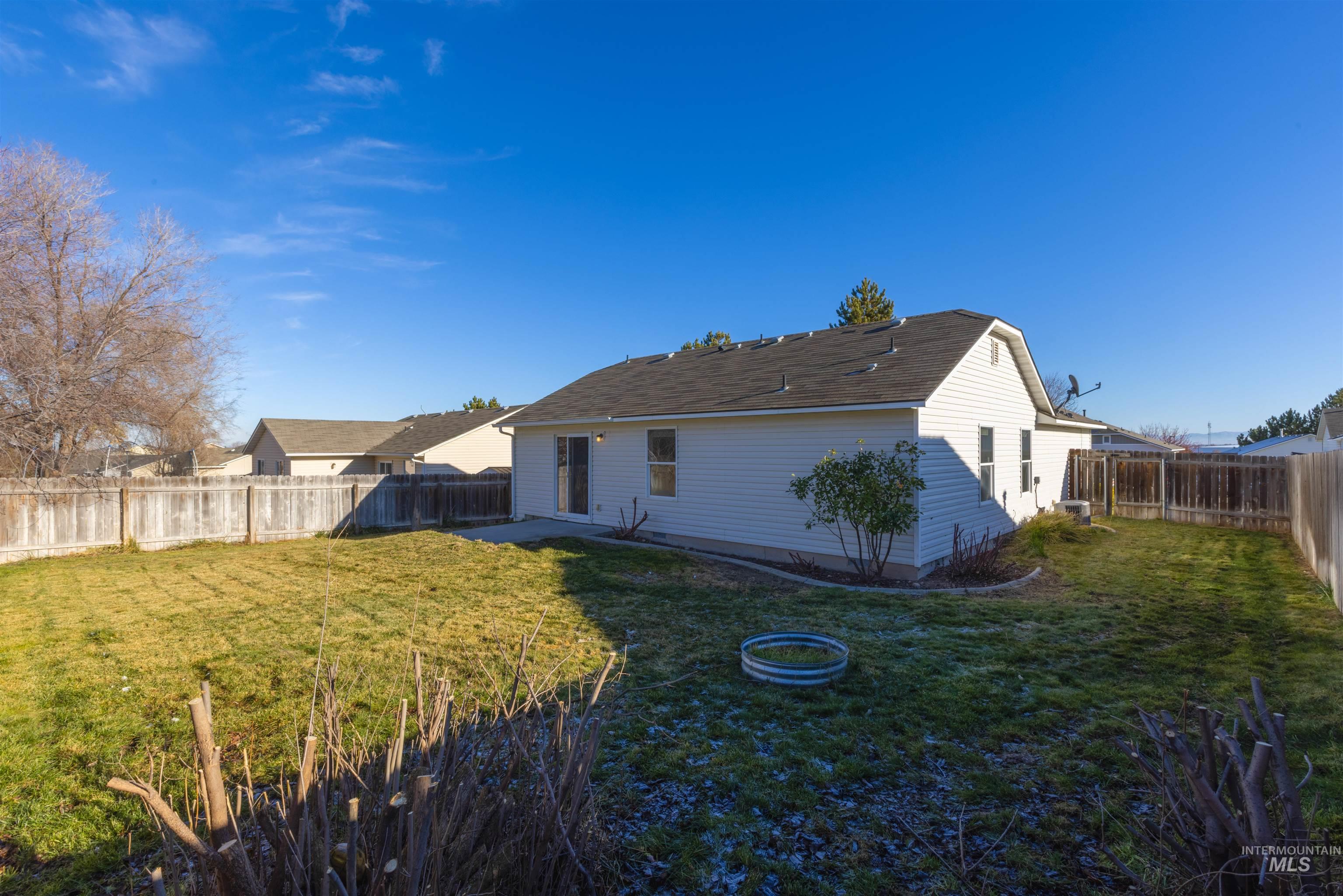 16535 Chino Avenue Caldwell, ID 83607 - Photo 26 of 26 Back of house featuring a patio and a fenced backyard