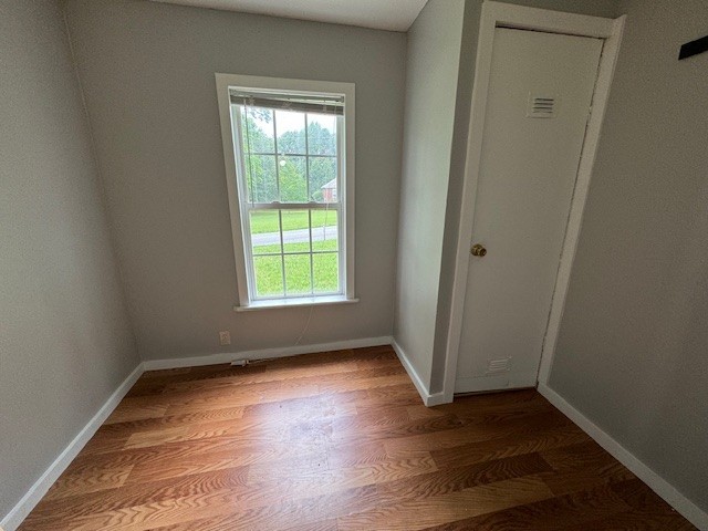 301 Eastbrook Road Estill Springs, TN 37330 - Photo 5 of 7 an empty room with wooden floor and windows