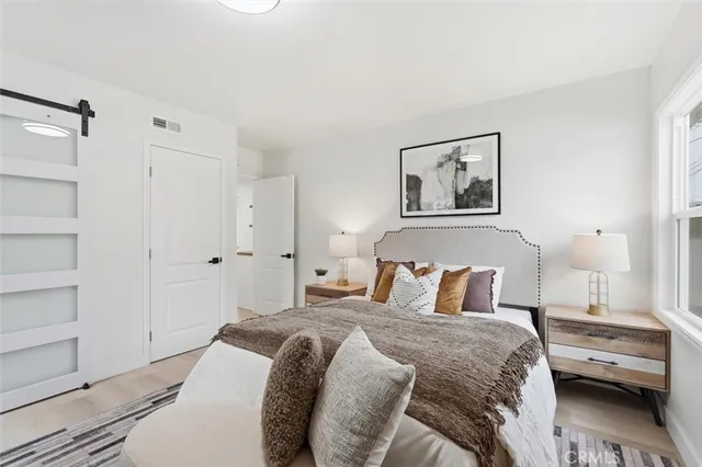 a bedroom with a bed and a window