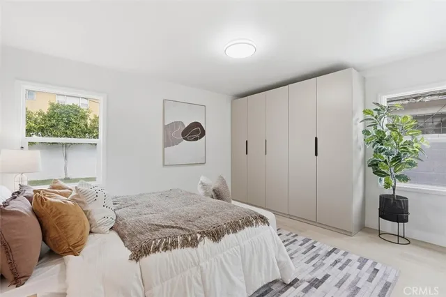 a bedroom with a bed and a potted plant