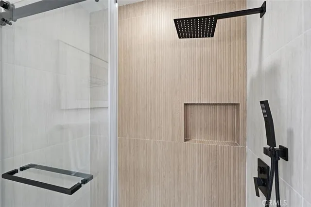 a bathroom with a toilet a sink a mirror and bathtub