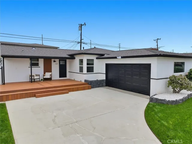 a view of a house with backyard and sitting area