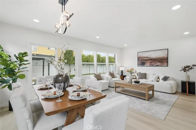 a living room with furniture potted plant and a large window
