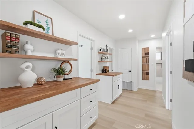 a spacious bathroom with a granite countertop sink and a mirror