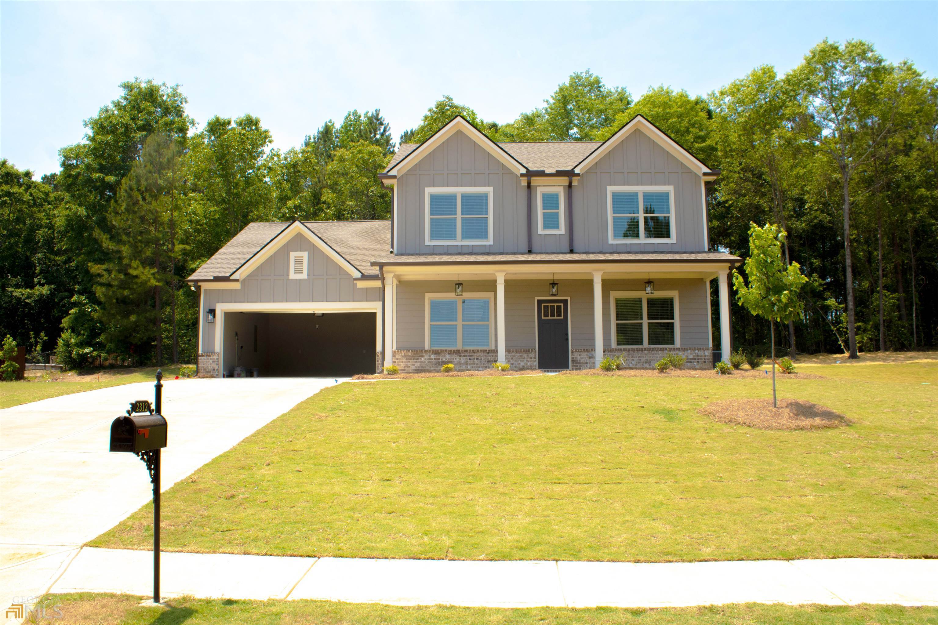 2312 Ridgeview Drive Loganville, GA 30052 - Photo 1 of 1 a front view of a house with a swimming pool