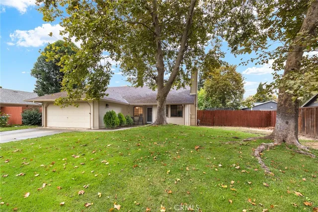 a front view of a house with yard and green space