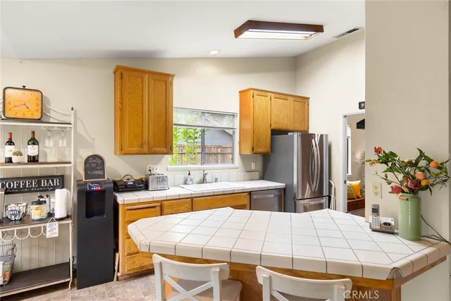 a kitchen with a refrigerator and a stove