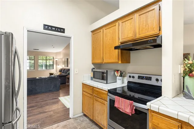 a kitchen with kitchen island granite countertop a stove and a sink