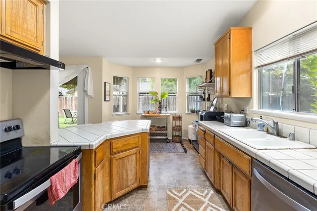 a kitchen with sink stove and cabinets
