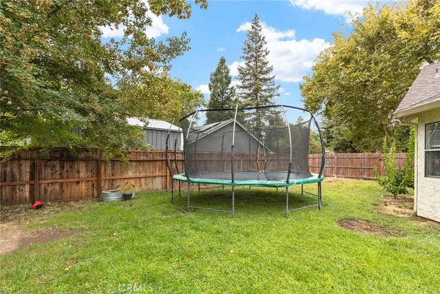 a view of a house with a backyard and a slide