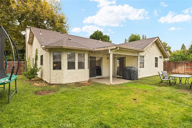 a view of a house with a yard and a porch