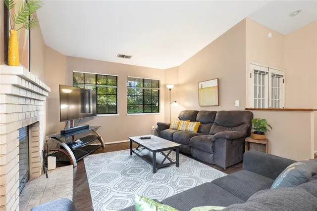 a living room with furniture rug and outdoor view
