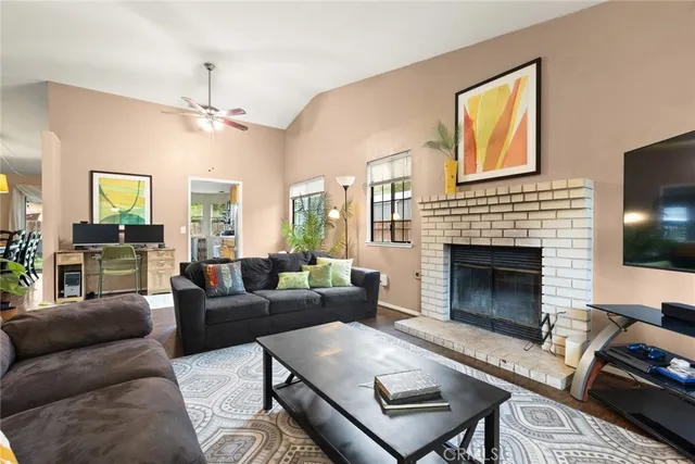 a living room with furniture fireplace and flat screen tv