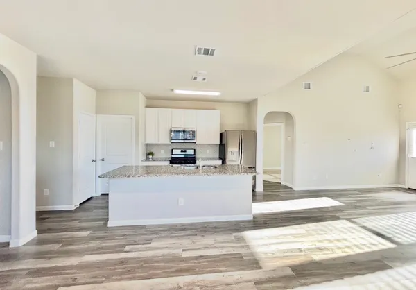 a view of kitchen with stainless steel appliances refrigerator stove microwave and stove