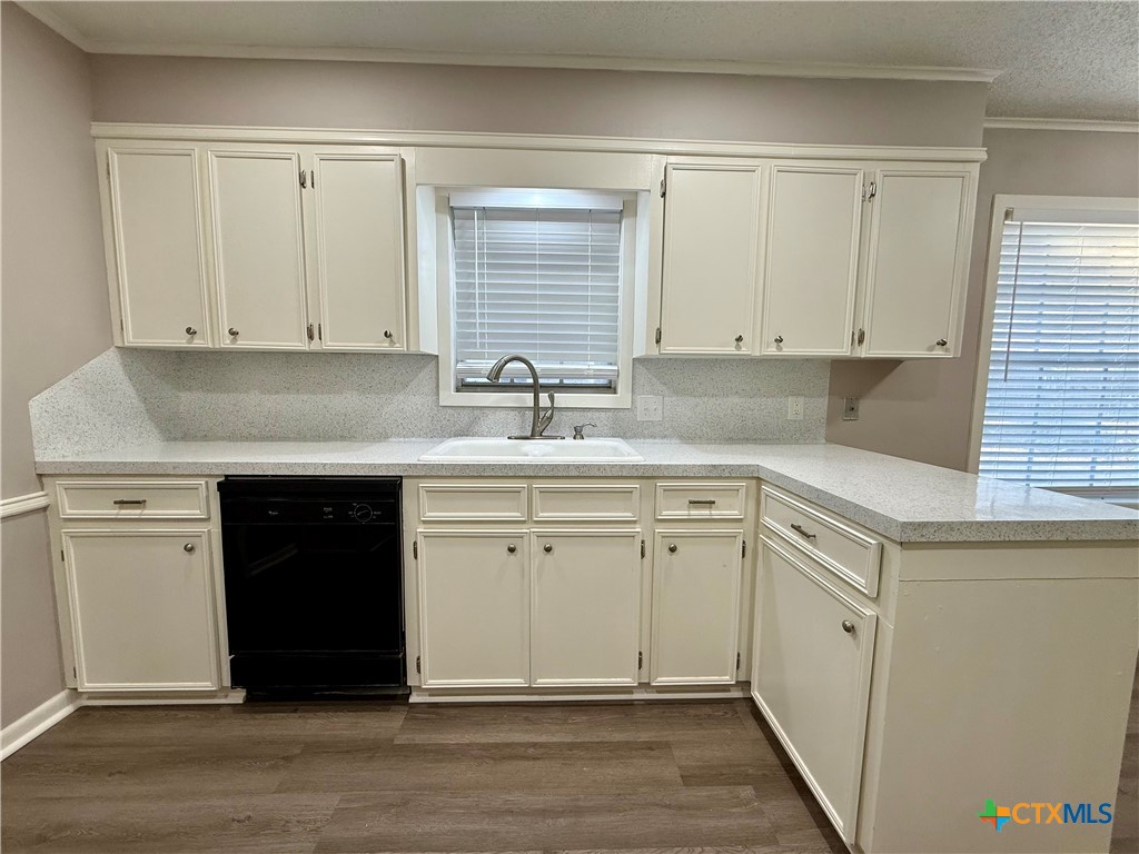 2407 East Airline Road Victoria, TX 77901 - Photo 11 of 38 a kitchen with granite countertop white cabinets and white appliances