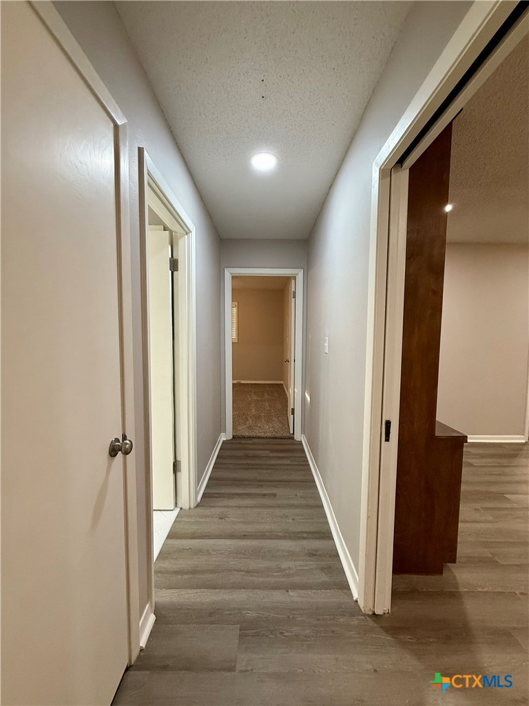 2407 East Airline Road Victoria, TX 77901 - Photo 13 of 38 a view of a hallway with wooden floor and staircase