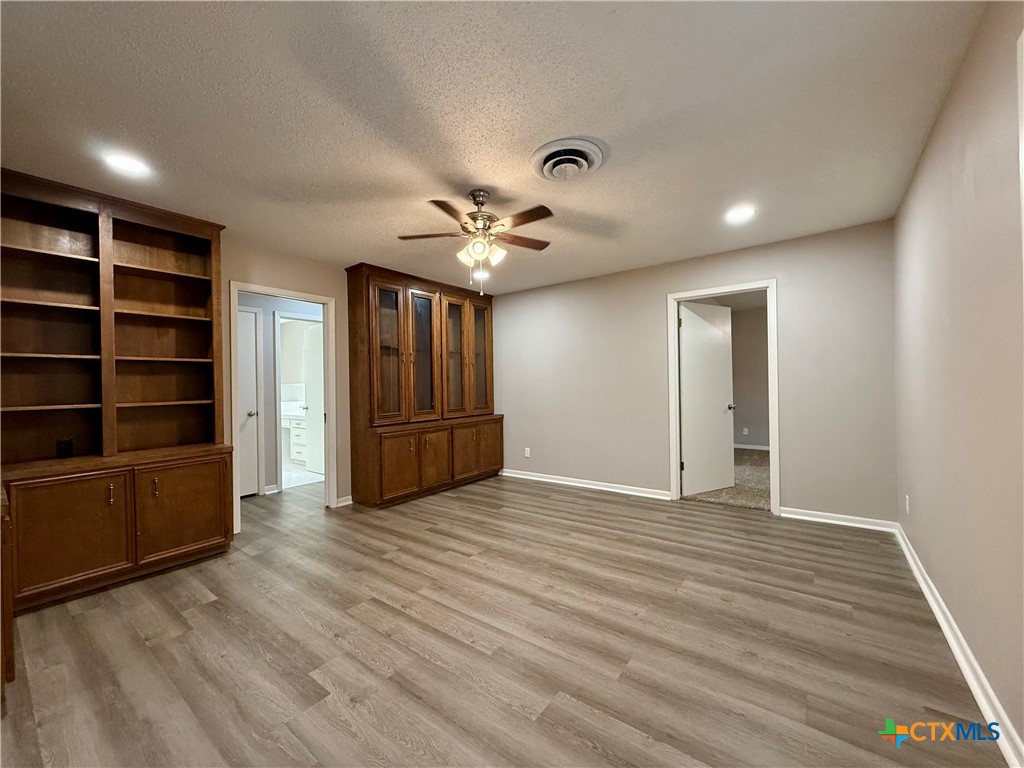 2407 East Airline Road Victoria, TX 77901 - Photo 14 of 38 a view of an empty room with a fireplace and a window