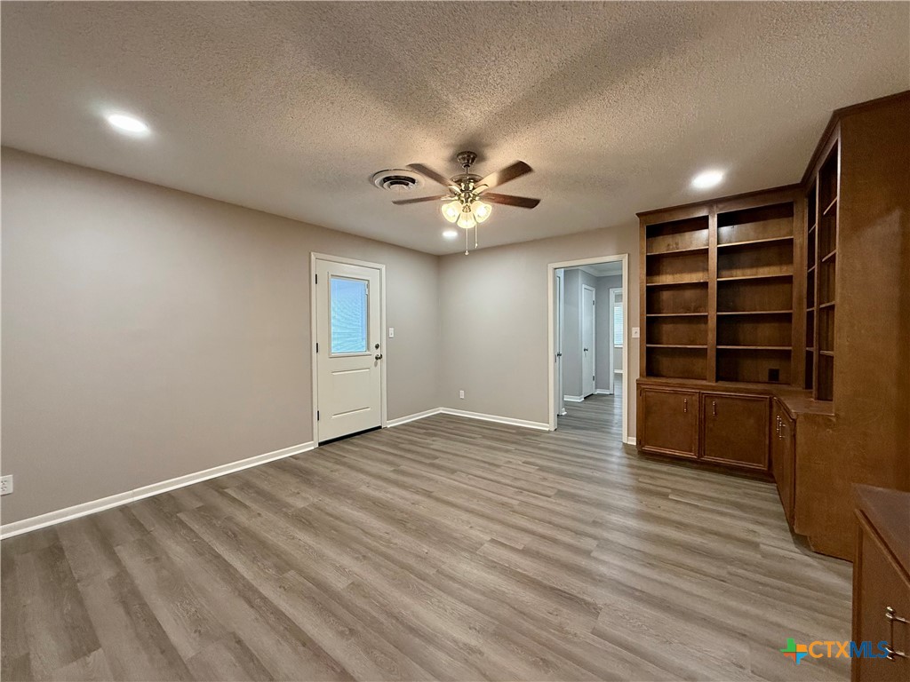 2407 East Airline Road Victoria, TX 77901 - Photo 15 of 38 a view of an empty room with a window and wooden floor