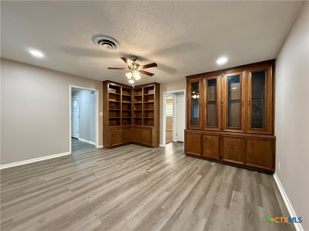 2407 East Airline Road Victoria, TX 77901 - Photo 16 of 38 wooden floor in an empty room with a window