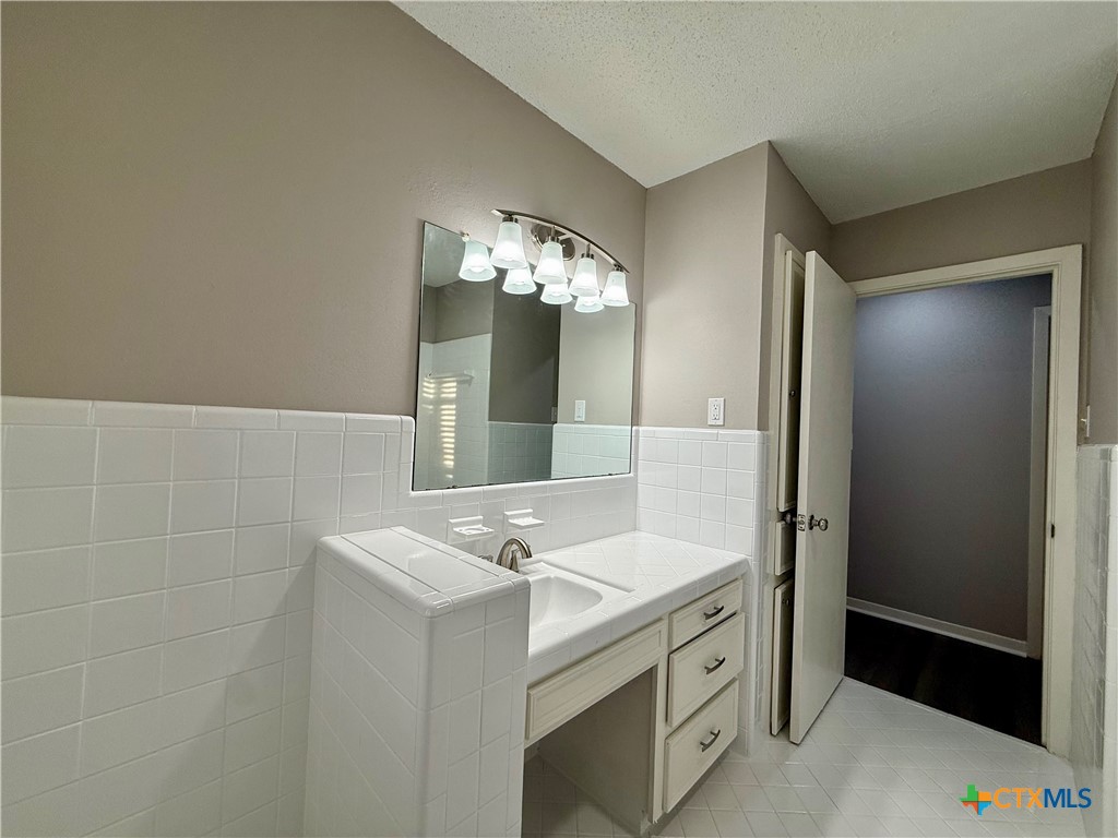2407 East Airline Road Victoria, TX 77901 - Photo 24 of 38 a bathroom with a sink and a mirror