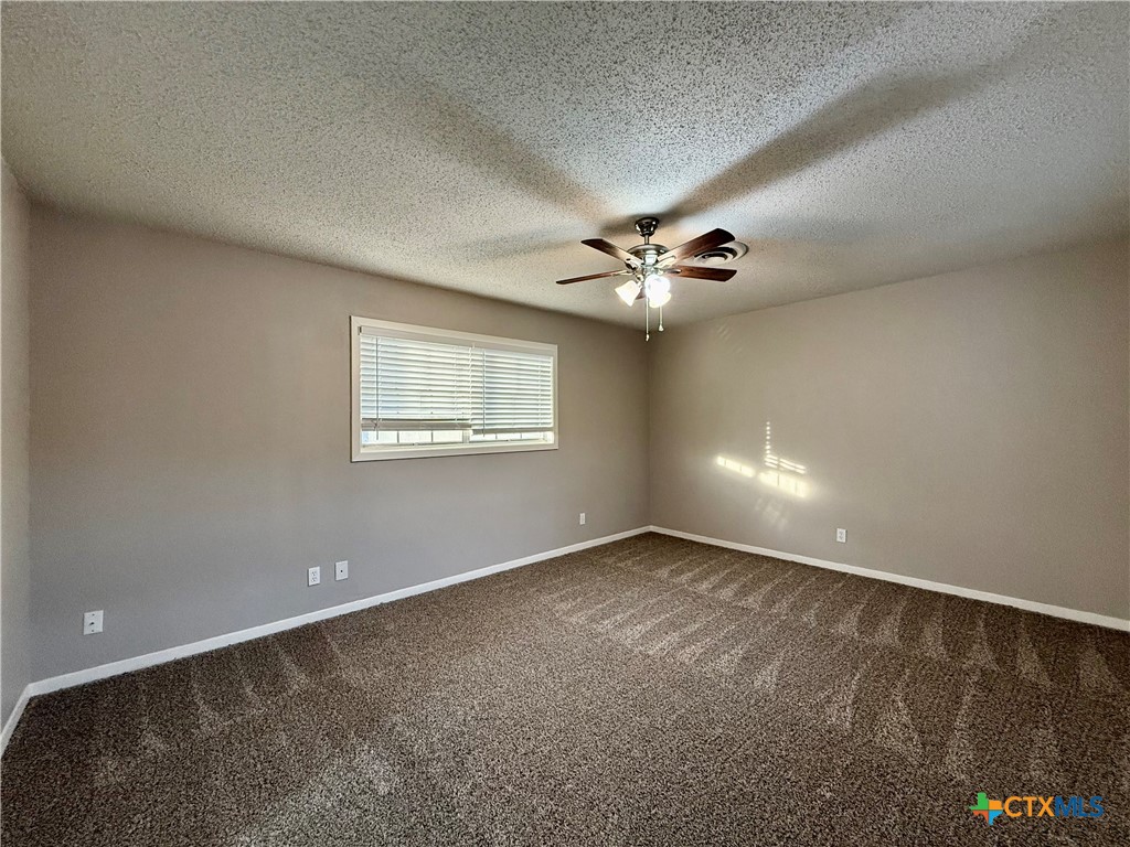 2407 East Airline Road Victoria, TX 77901 - Photo 26 of 38 a view of an empty room with a chandelier fan