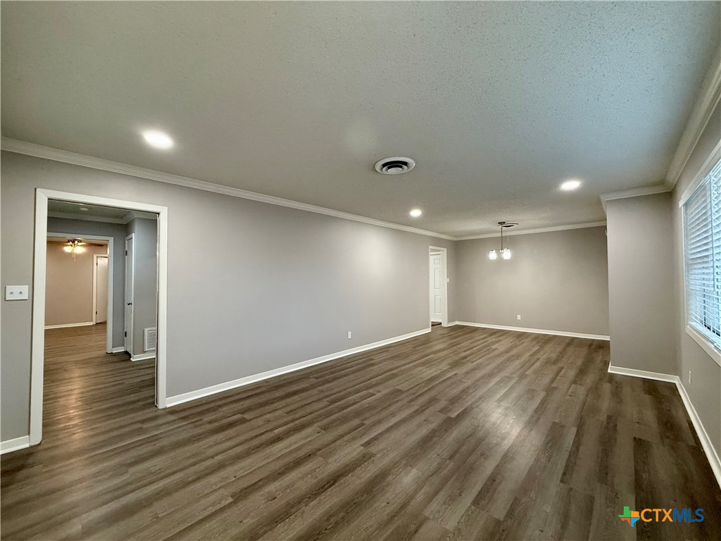2407 East Airline Road Victoria, TX 77901 - Photo 5 of 38 an empty room with wooden floor and windows