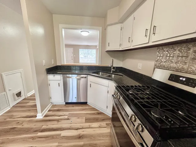 a kitchen with granite countertop a stove and a sink