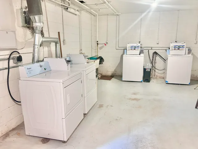 a utility room with multiple dryer and washer