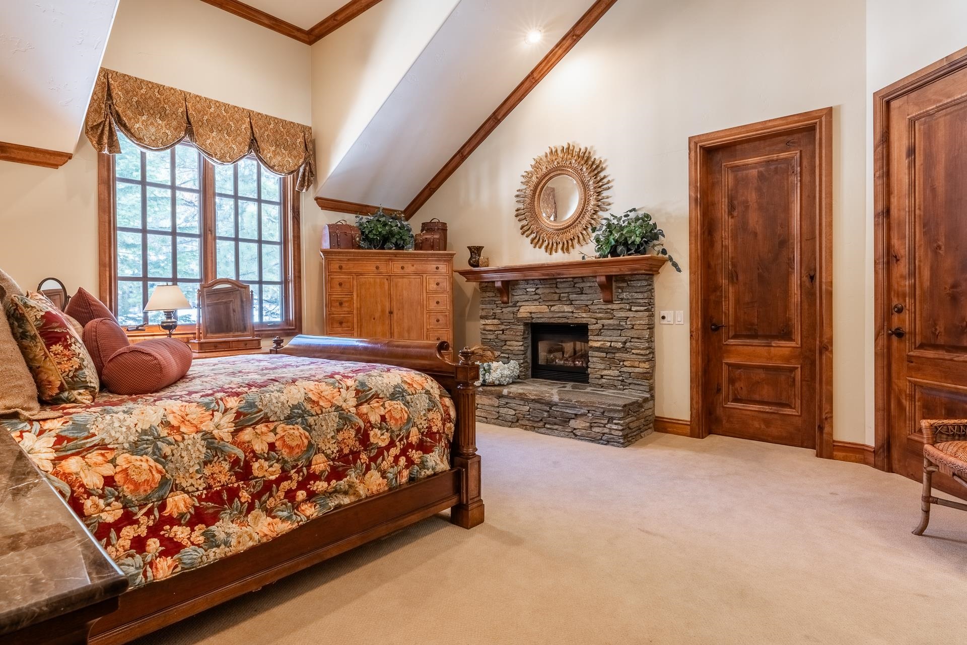 105 Northstar Circle Mammoth Lakes, CA 93546 - Photo 25 of 49 a bed sitting in a spacious bedroom next to a fireplace
