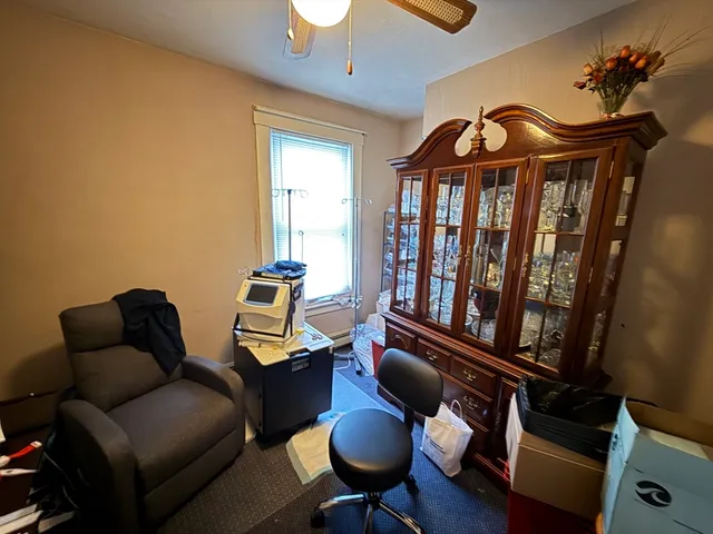 a view of a dining room with furniture a chandelier and wooden floor
