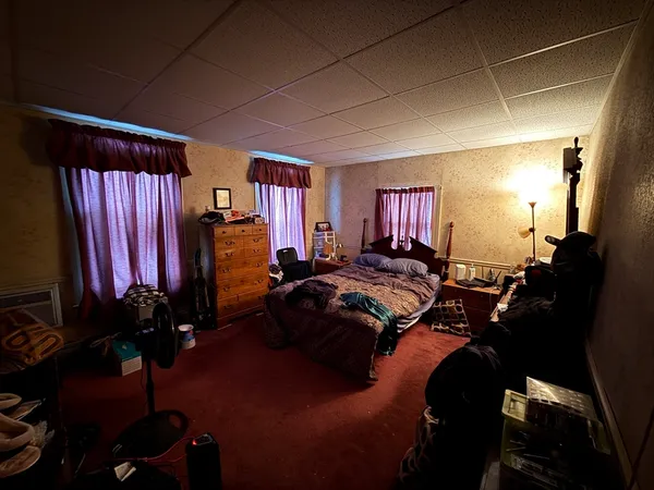 a bedroom with a bed and a chandelier