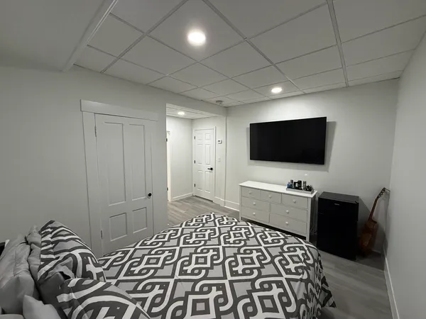 a hotel room with two bed and a flat screen tv
