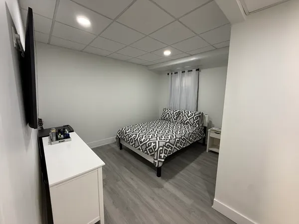 a room with a bed and a flat screen tv
