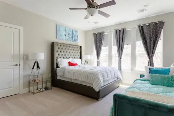 a bedroom with a bed and a chandelier