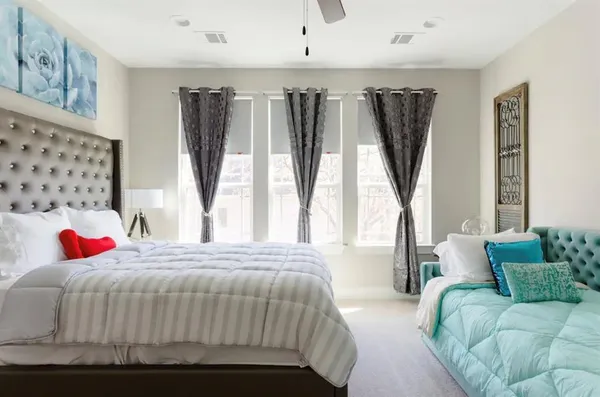 a bedroom with a bed couch and a window