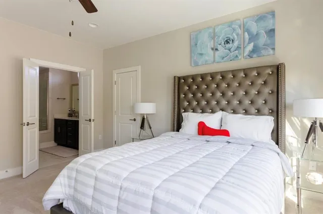 a bedroom with a bed and a lamp