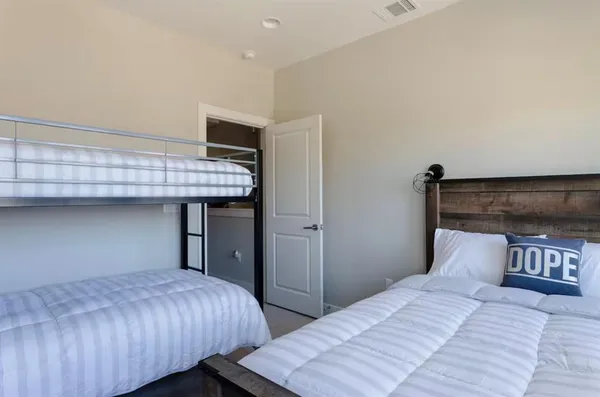 a bedroom with bed and wooden floor