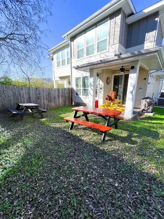 a backyard of a house with yard and outdoor seating