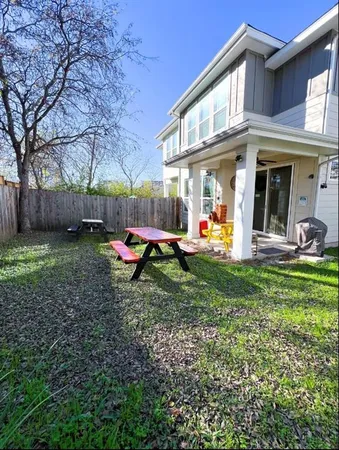a view of a house with a yard patio and fire pit