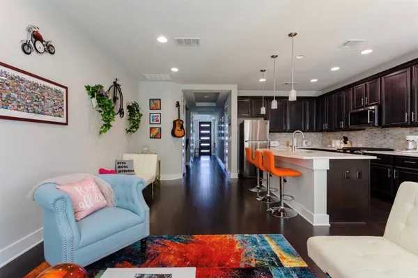 a living room with furniture and kitchen view