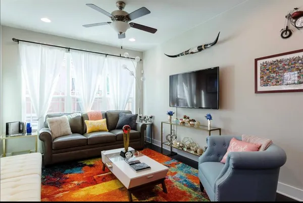 a living room with furniture and a flat screen tv