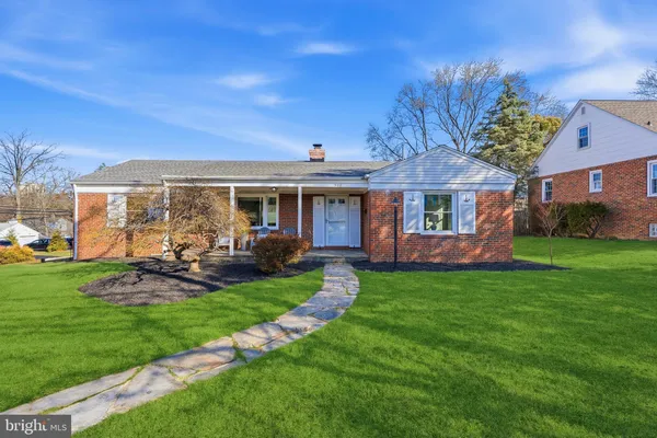 a view of a house with a yard porch and sitting area