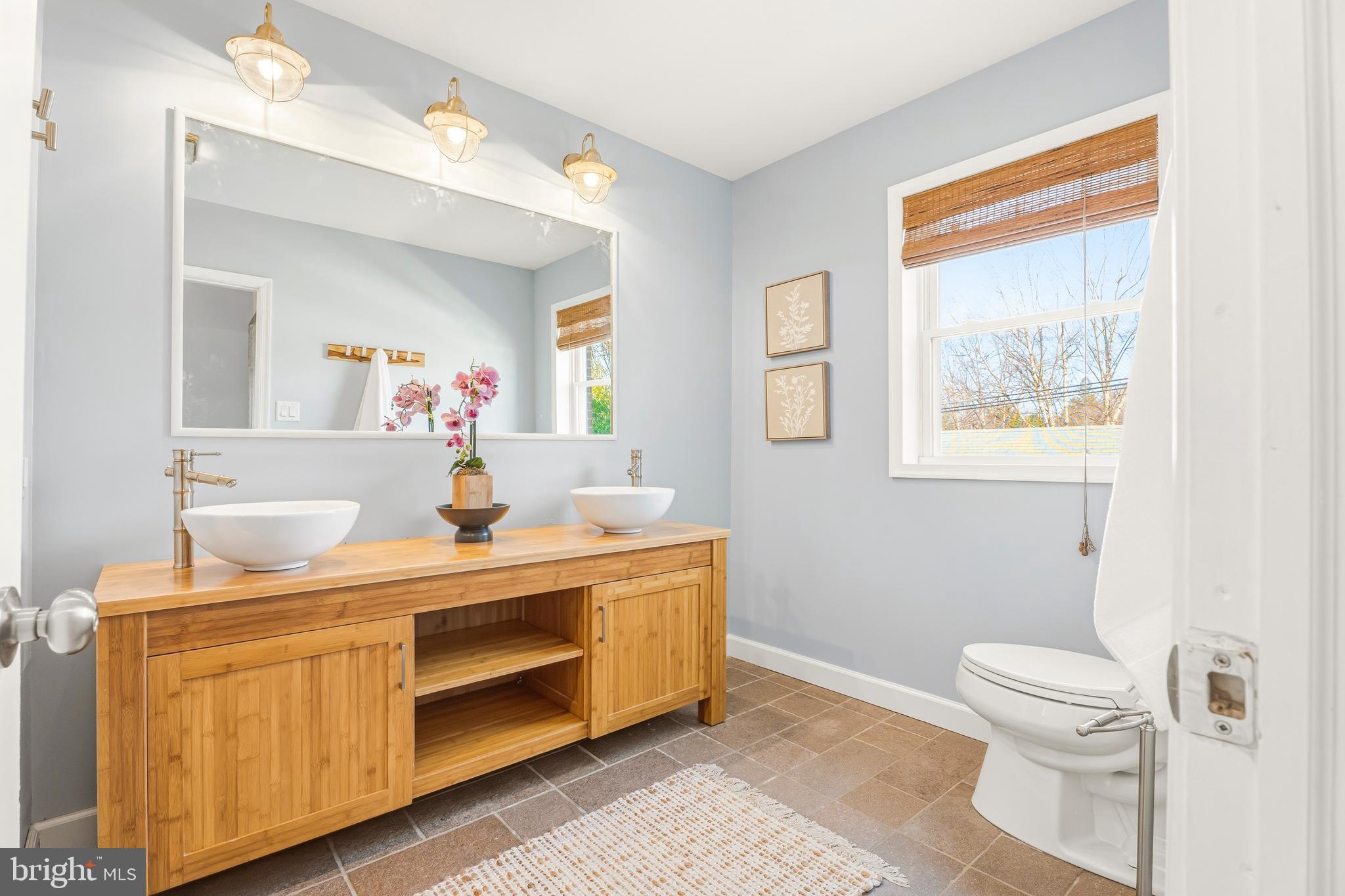 500 Hillen Road Towson, MD 21286 - Photo 17 of 42 a bathroom with a toilet sink and mirror