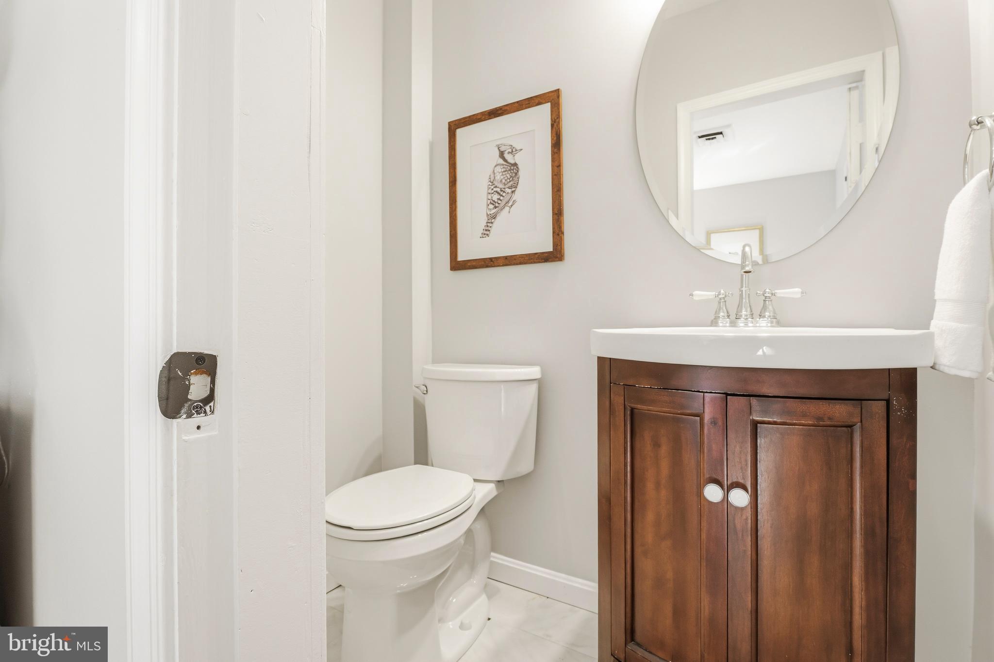 500 Hillen Road Towson, MD 21286 - Photo 21 of 42 a bathroom with a toilet a sink and mirror