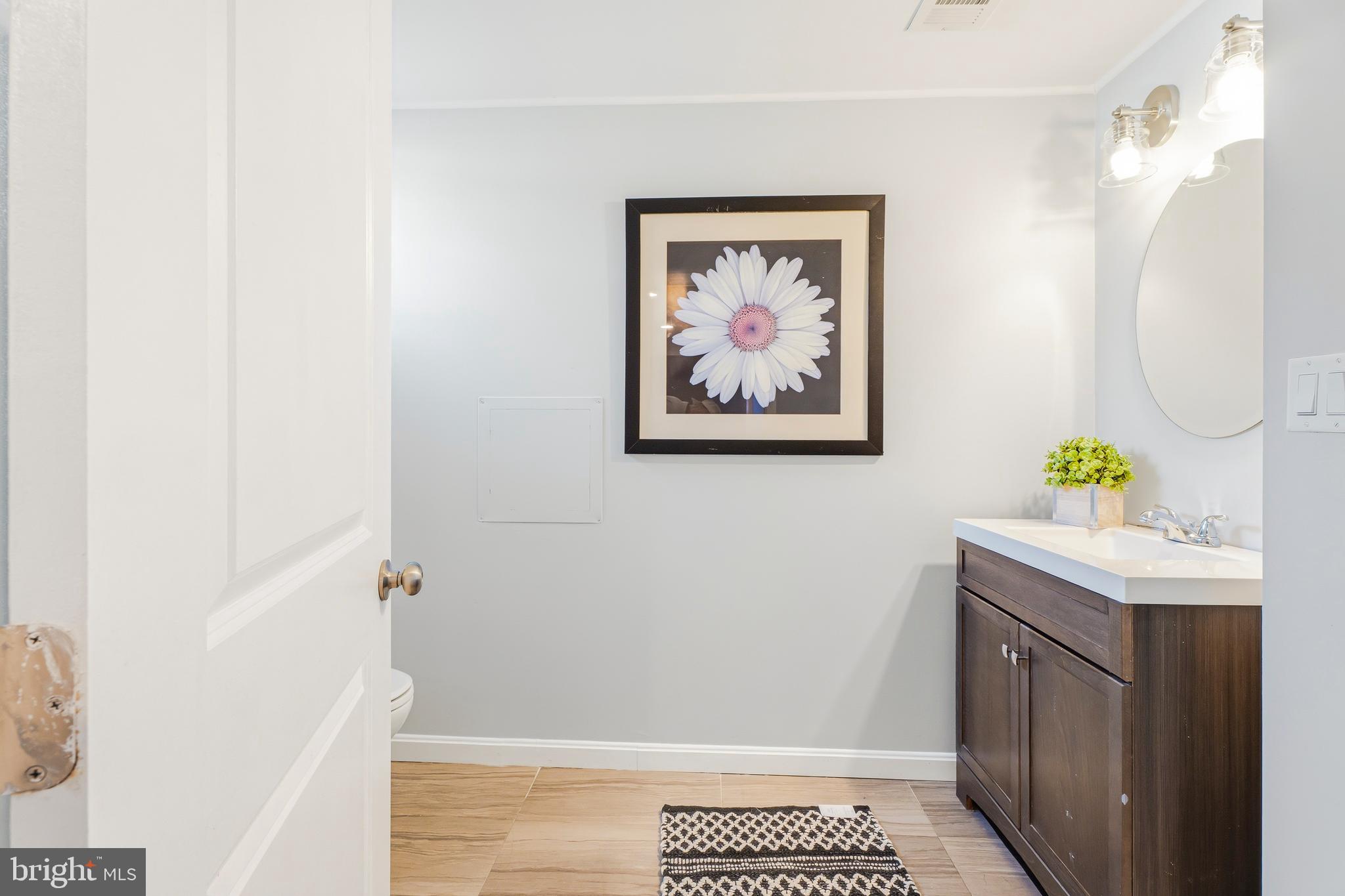 500 Hillen Road Towson, MD 21286 - Photo 32 of 42 a bathroom with a granite countertop sink a vanity and a shower
