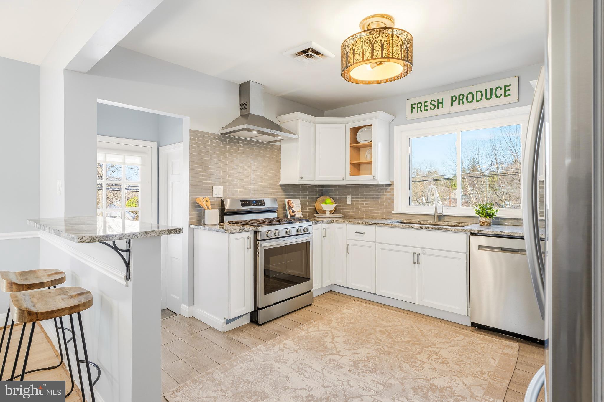 500 Hillen Road Towson, MD 21286 - Photo 9 of 42 a kitchen with stainless steel appliances granite countertop a stove a sink and a microwave