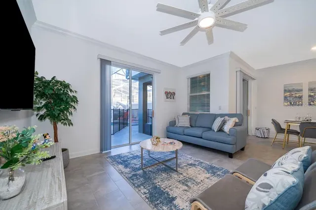 a living room with furniture potted plant and a window