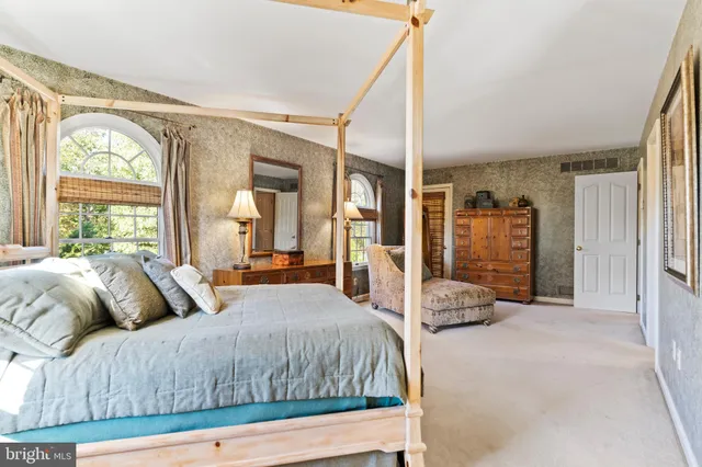 a room with furniture a flat screen tv and dresser