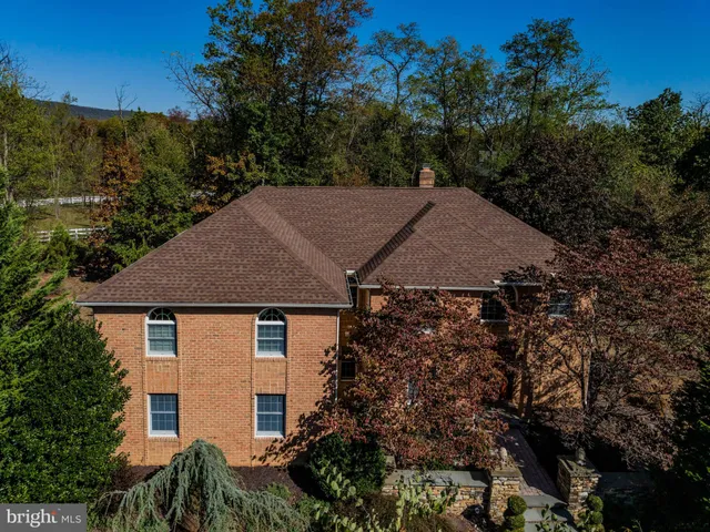 a aerial view of a house with a yard and tree s
